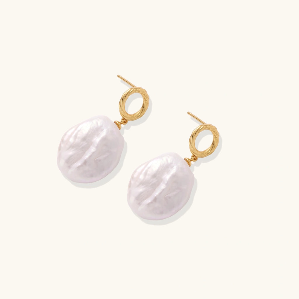 Baroque pearl drop earrings with 18K gold vermeil studs shown at an angle