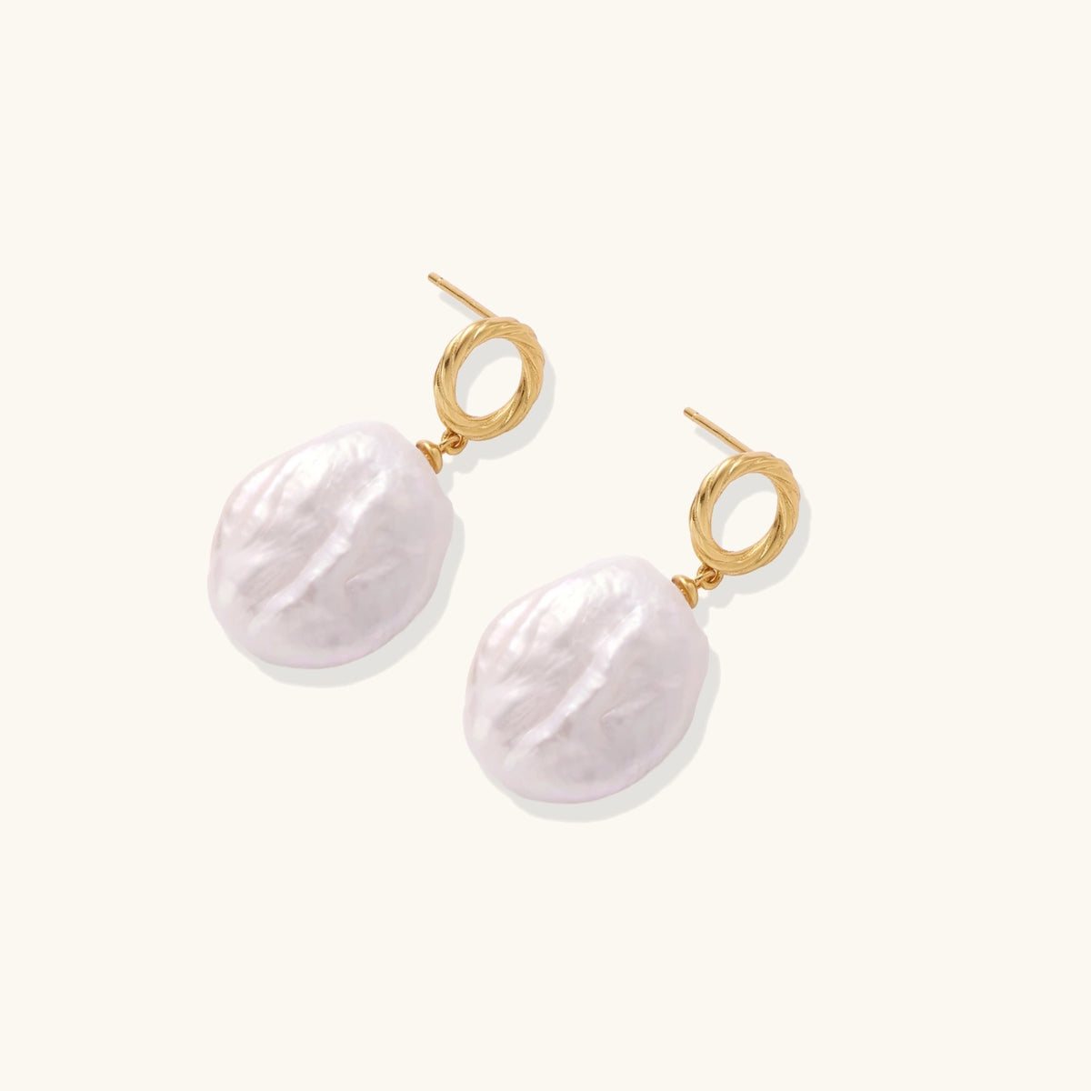 Baroque pearl drop earrings with 18K gold vermeil studs shown at an angle